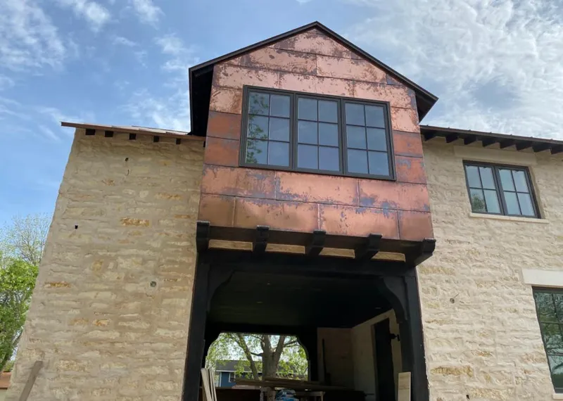 Copper metal panel facade on a stone building for Skylight Installation in Haddam
